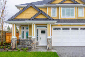 exterior of home with yellow siding and a new front door