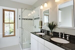 a newly remodeled shower with glass doors and tile surround